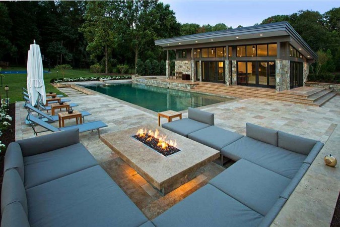 An outdoor living area with a fire pit that heats up your landscape.