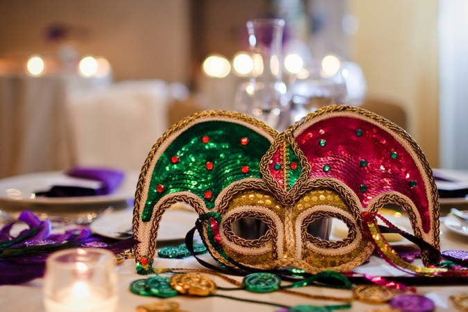A Mardi Gras mask on a table, tribute to New Orleans.