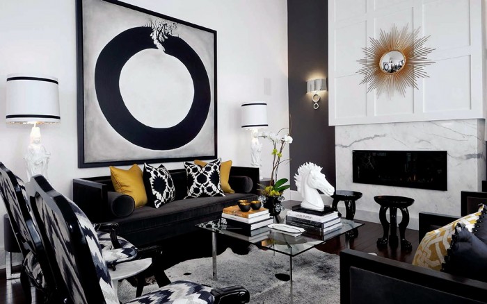 A fashionable home interior featuring a black and white living room with a large black and white painting.