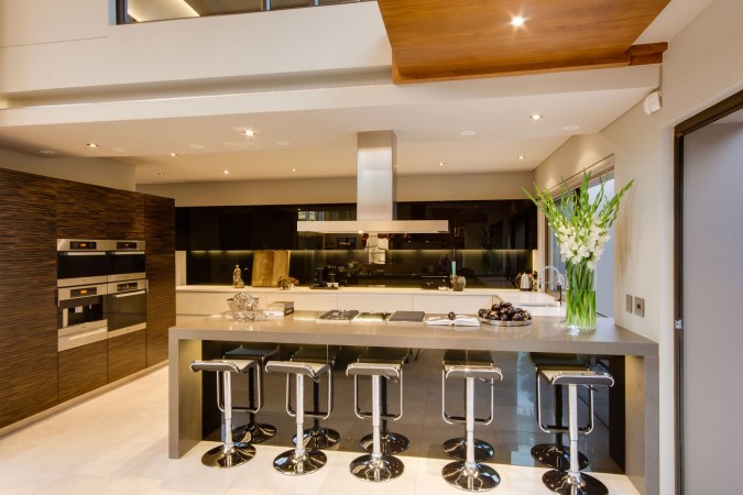 A modern kitchen with a large island and 18 stylish bar stools for your kitchen.