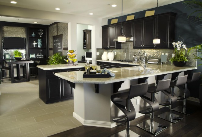 A kitchen with a center island and stylish bar stools.