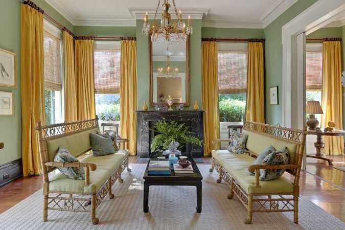 A vibrant living room with green walls and yellow furniture, paying tribute to New Orleans on Mardi Gras.
