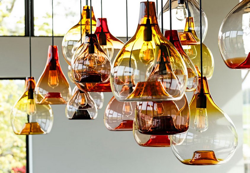 13 Beautiful and Unique glass pendant lights hanging in a room.