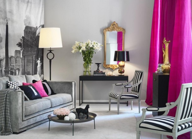 A monochrome living room with vibrant pink curtains.