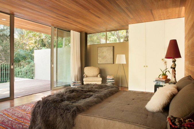 A Mid-Century Modern Bedroom with a wooden ceiling.