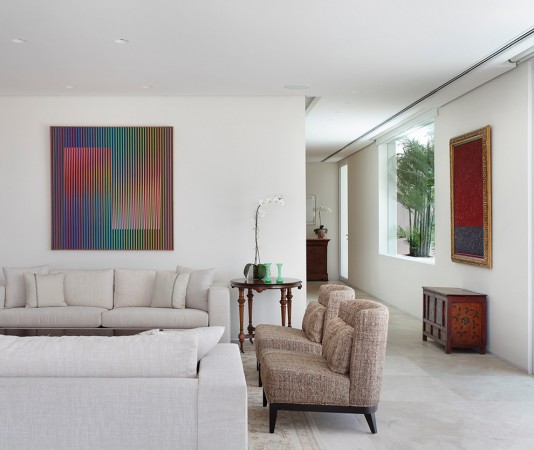 Using abstract art in a white living room.