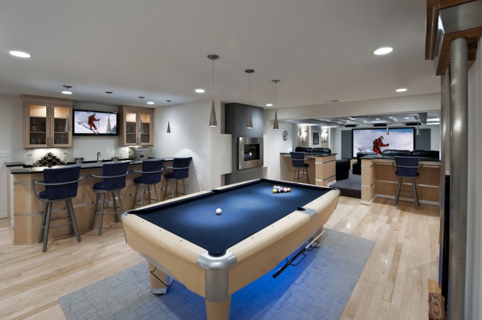 A creative game room featuring a pool table and TV, perfect for basement entertainment.