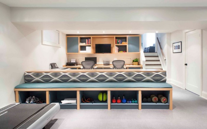 A creative home office with a desk and a treadmill.