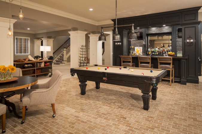 A creative use for the basement - a game room with a pool table and bar.