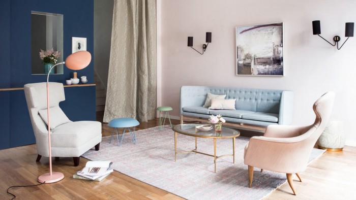 A living room with sophisticated and feminine pink furniture.