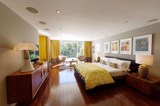 A Mid-Century Modern bedroom with a bed and a TV.
