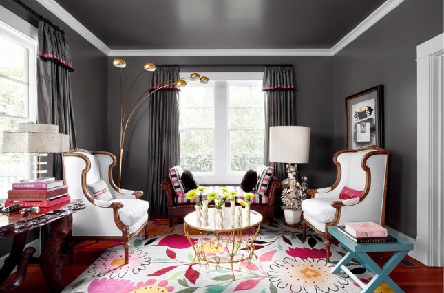 A sophisticated living room with black walls and a colorful rug designed for the modern woman.