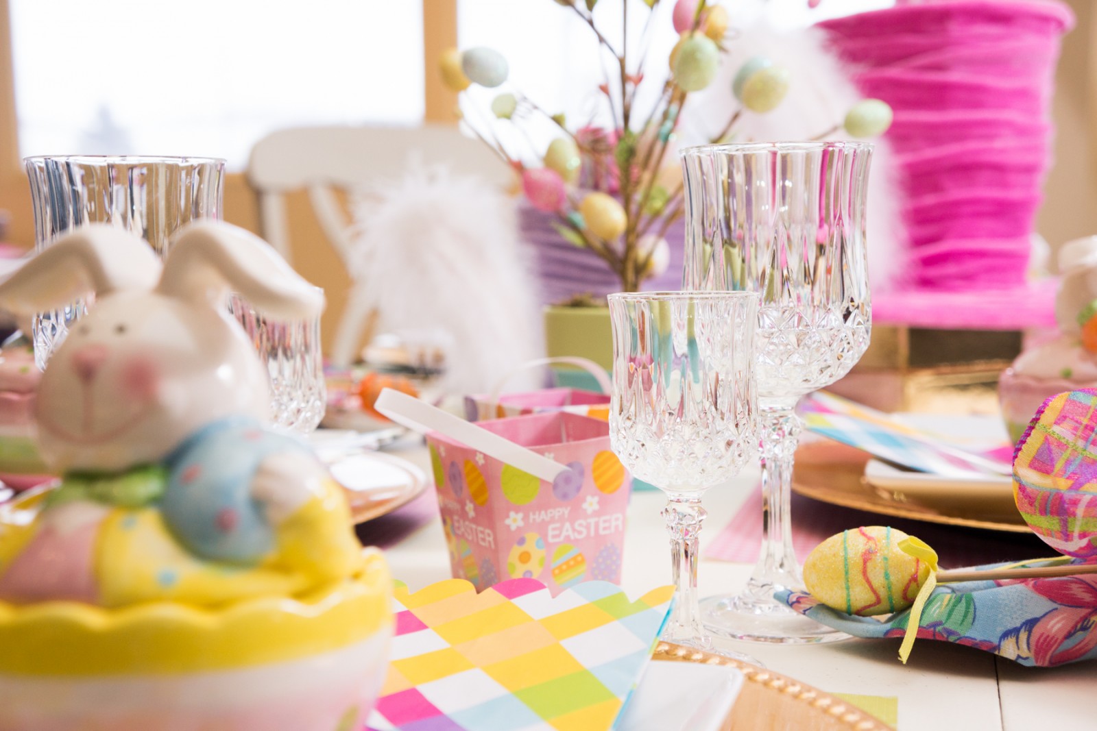 Easter table setting with festive bunny figurines.
