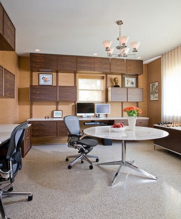 A modern office with a desk and chairs designed in the Mid-Century Modern style.