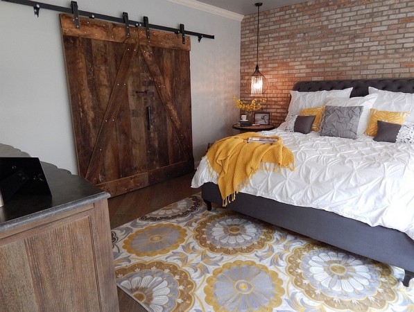A bedroom with a bed and a bedside table transformed into 10 Creative Uses for the Basement.