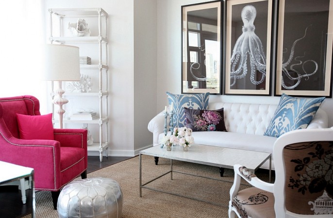 Sophisticated feminine living room with a white couch and a pink chair.