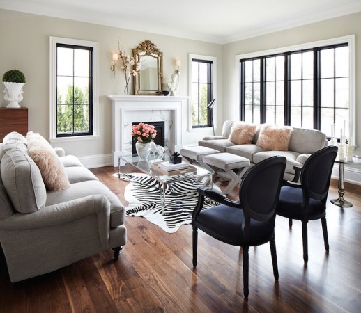 A sophisticated living room with a fireplace and zebra rug designed for the modern woman.