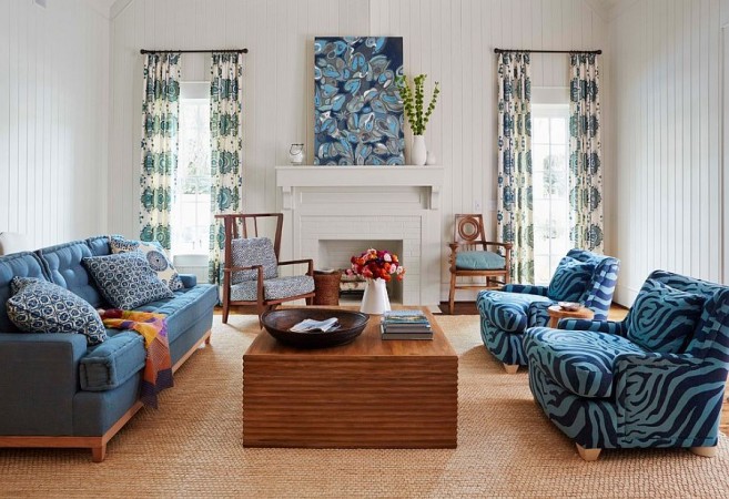 A spring-inspired living room with blue furniture and a fireplace.