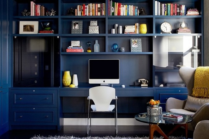 A mid-century modern home office with a desk and bookshelves.