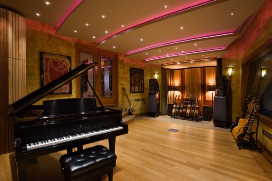 A recording studio with a piano and guitars transformed from the basement.