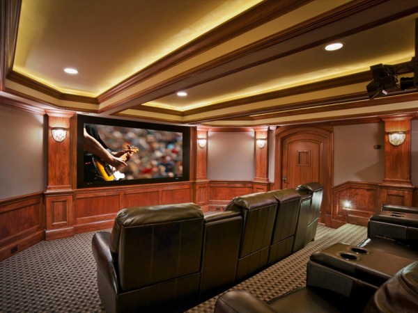 A home theater with leather seating and a television in the basement.