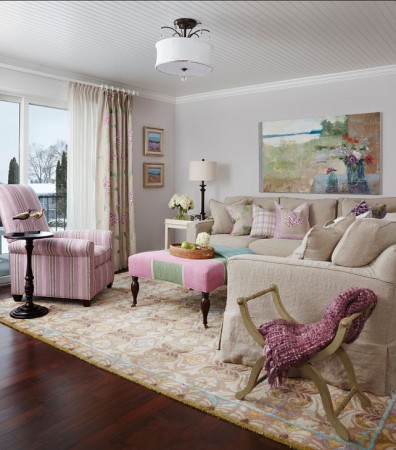 A living room with sophisticated and feminine pink couch and chairs.