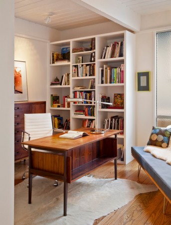 A Mid-Century Modern desk with bookshelves.