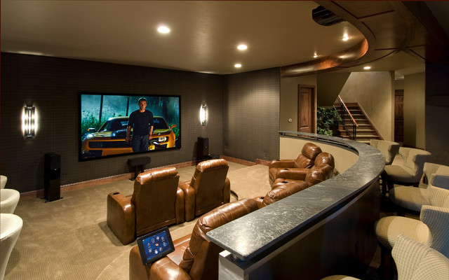 A  home theater room with a flat screen tv.