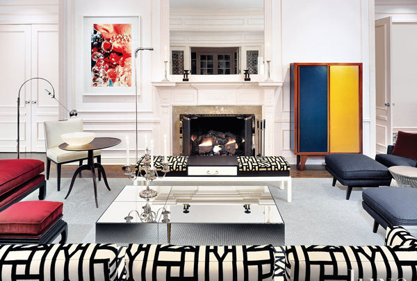 A living room with colorful furniture and abstract art.