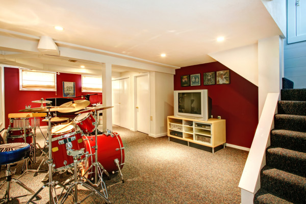 A drum set in a creatively utilized basement.