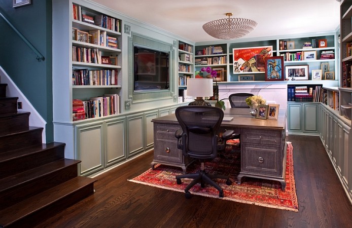 A creative home office with desk and bookshelves in the basement.