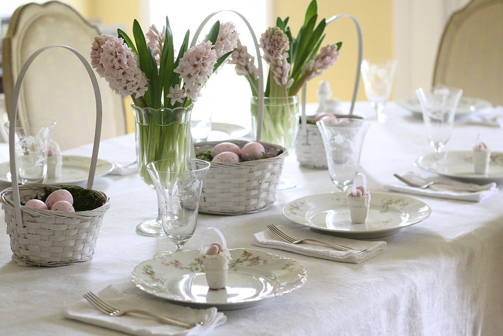 Easter table setting with fresh hyacinth baskets.