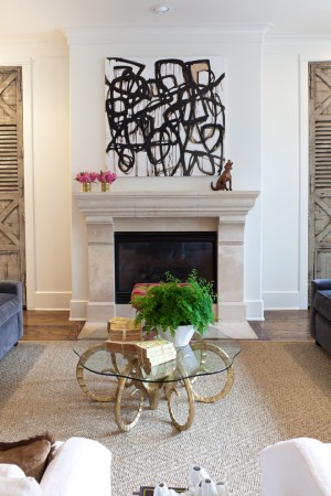 A living room with an abstract art fireplace.