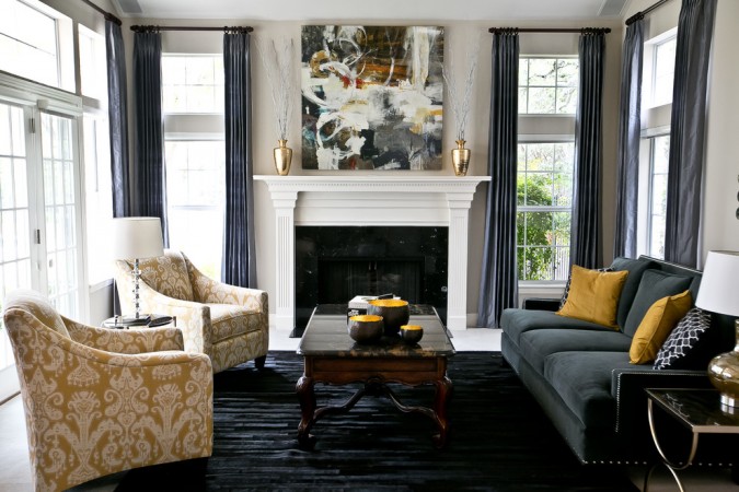 A vibrant living room with black and yellow furniture adorned with abstract art.