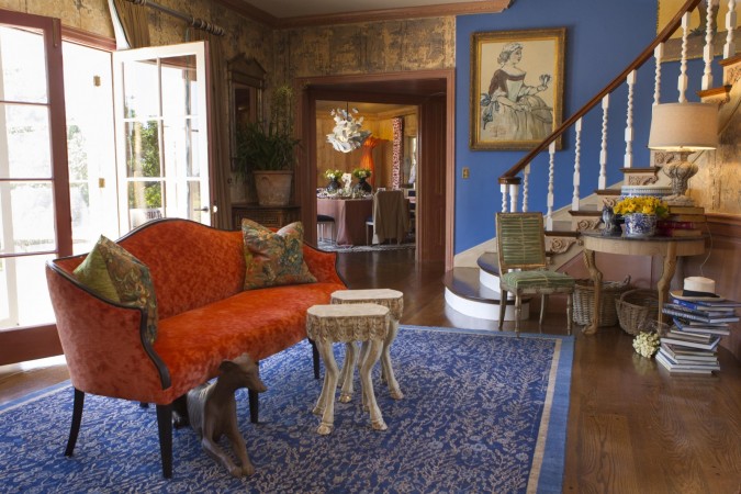 A designer living room with an orange rug.