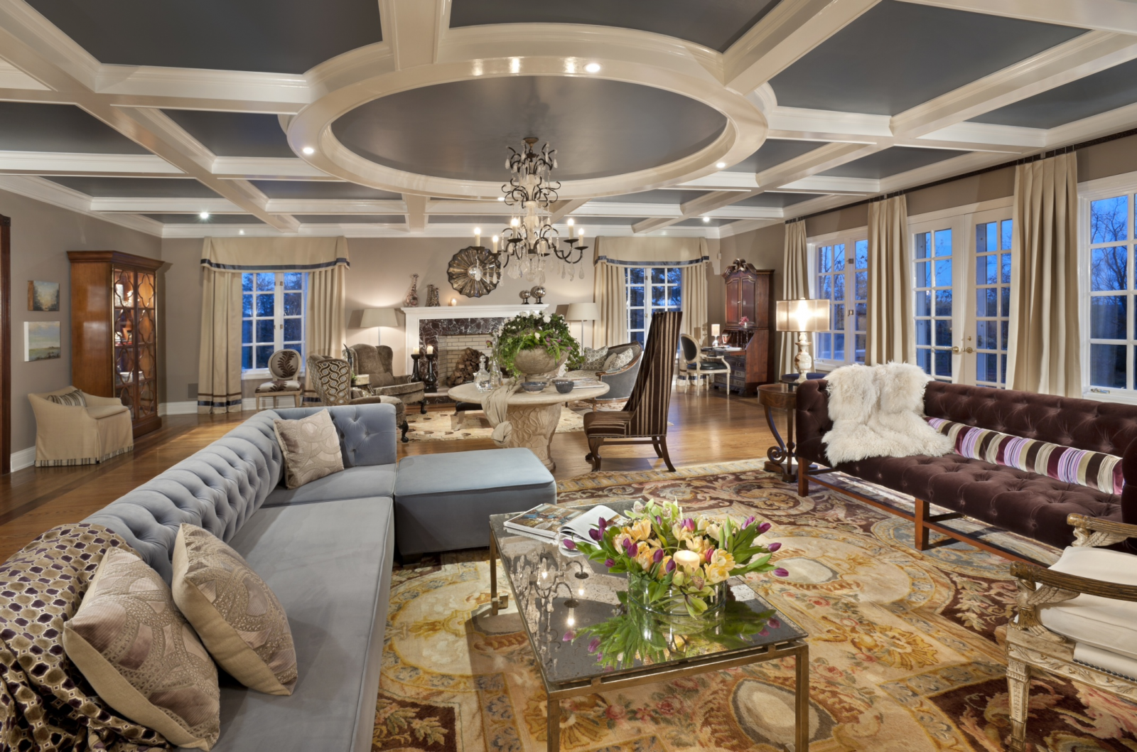 A large living room with a chandelier showcased in 20 Designer Showhouse Rooms to Spark Your Inner Decorator.
