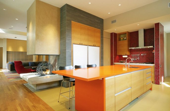 A modern kitchen with an orange island showcasing color and character.