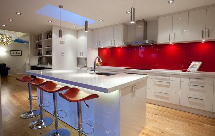 Bright red tile adds a splash of color to this modern kitchen