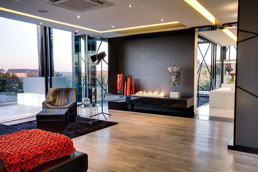 A modern living room with sculptural elements and large windows.