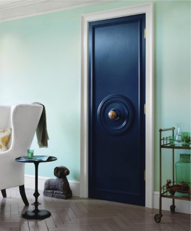 A unique blue door in a living room.