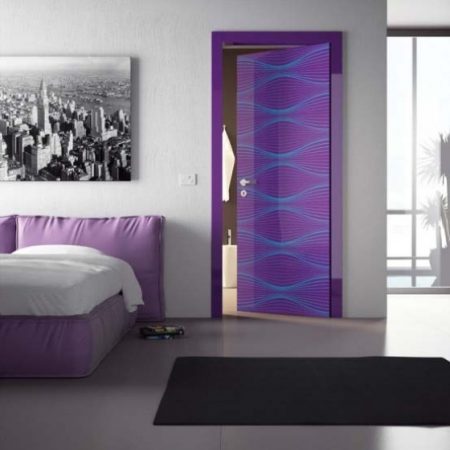 A purple door adorns a unique and stylish bedroom.