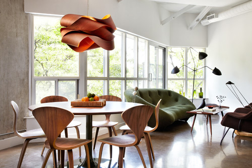 A dining room with a wooden table and chairs featuring sculptural elements.