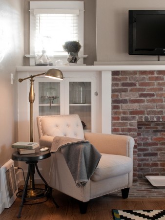 Creating a cozy corner retreat with a brick fireplace in your living room.