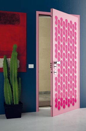 A unique pink door with a cactus on it is featured.