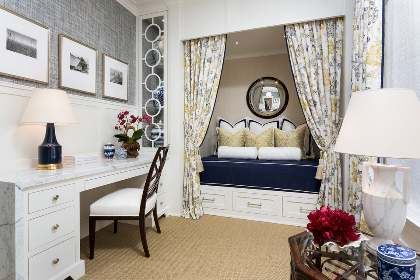 A cozy blue and white bedroom retreat with a desk and chair.