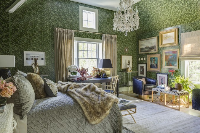 A bedroom with green wallpaper and a chandelier featured in 20 Designer Showhouse Rooms to Spark Your Inner Decorator.