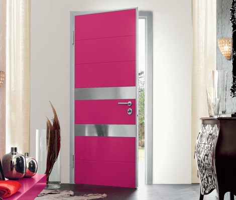 A unique pink and silver door in a living room.