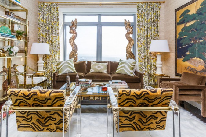 A living room with gold and brown furniture featured in 20 Designer Showhouse Rooms to Spark Your Inner Decorator.