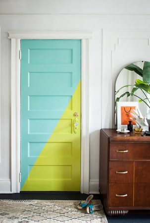An 8 Unique Interior Door Ideas featuring a brightly colored door in a room with a dresser.