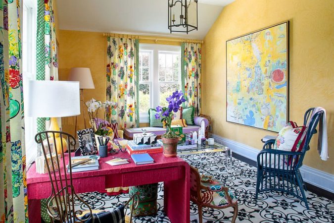 A room with colorful walls and an eclectic rug.
